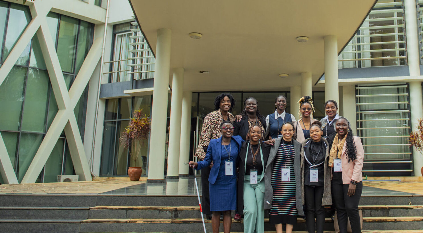 A group of women lawyers, CFJ fellows, photographed on the steps outside a host organisation building