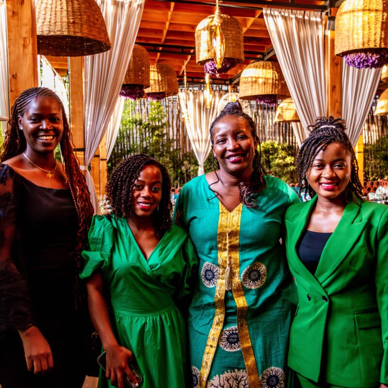 Four women smiling together at an outdoor Halcyon founder gathering