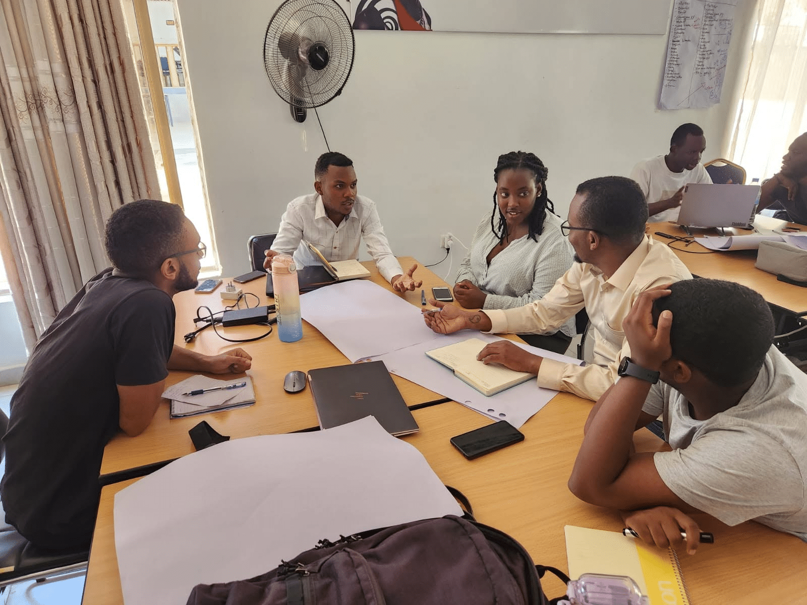 Jasiri Talent Investor Cohort 9 participants working together around a table during a venture building session.