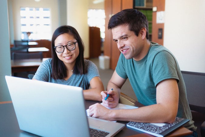 World Cancer Research Fund programme photograph of two researchers working at a laptop